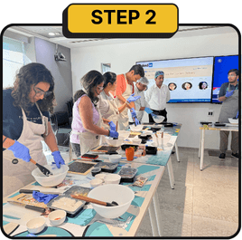 Step 2: guests in aprons making lippan art at a Kitsters station in an office