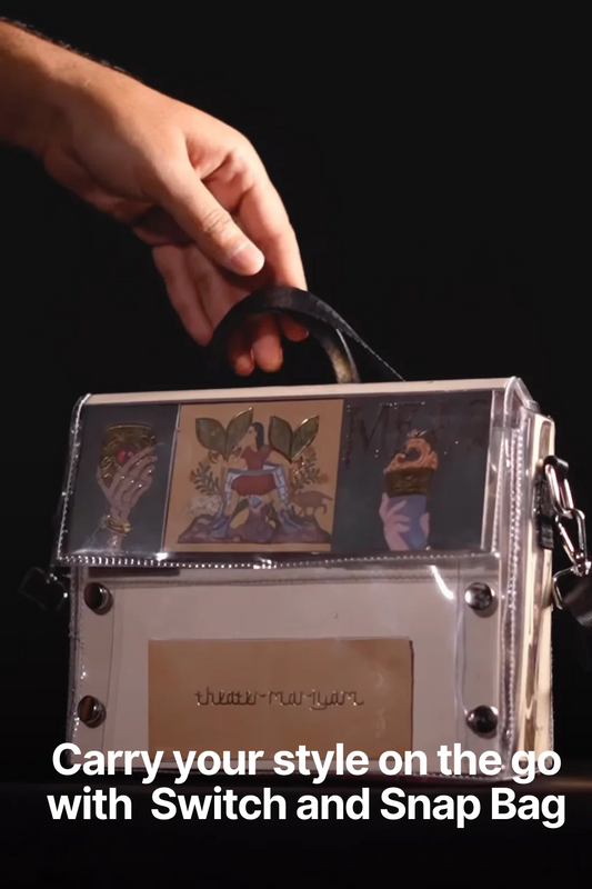 A stunning Switch and Snap Bag made up of a tasteful sweet box, held up elegantly against a deep black background 