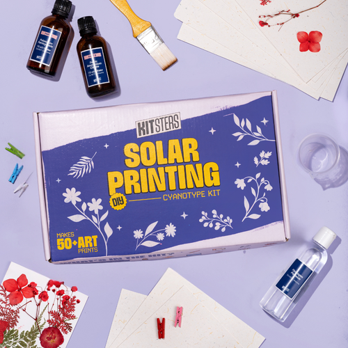 Kitsters DIY Solar Printing Kit with cyanotype-coated paper and botanical prints in vibrant Prussian blue