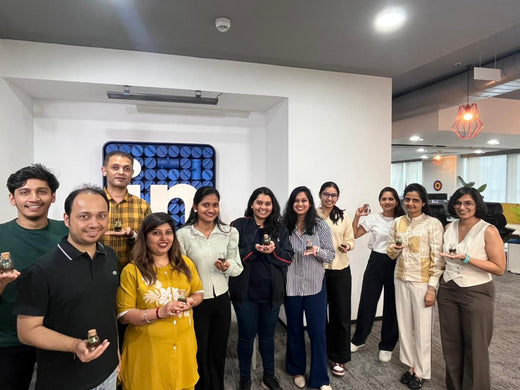 A team holding the pieces they made at an office session