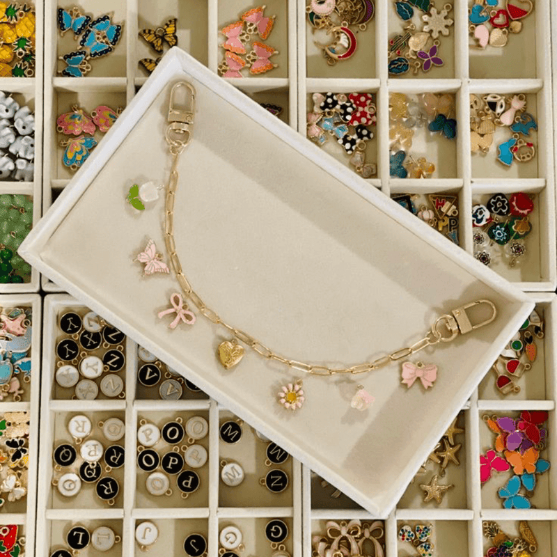 A jewellery-making tray with beads and findings sorted into compartments
