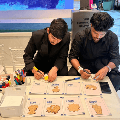 Two makers working through their Kitsters cards at a brand event