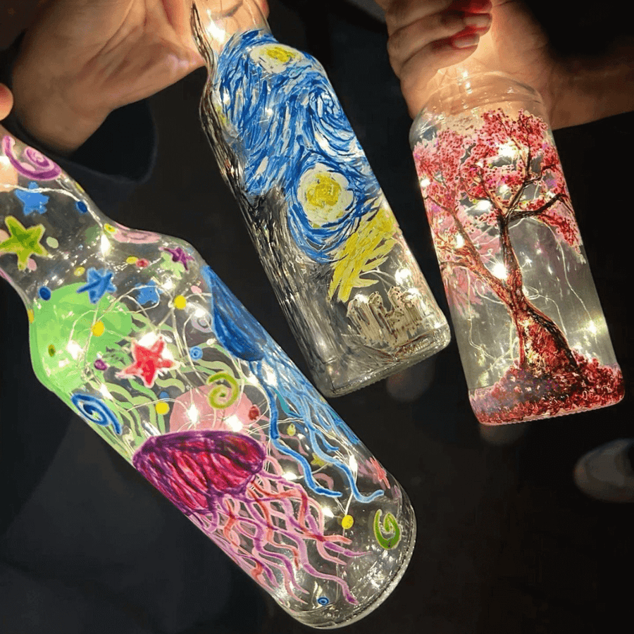 A row of hand-painted bottle lamps lined up after a Kitsters session
