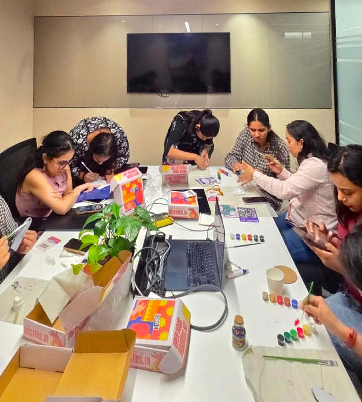 A room of colleagues around a boardroom table, each working through their own open kit